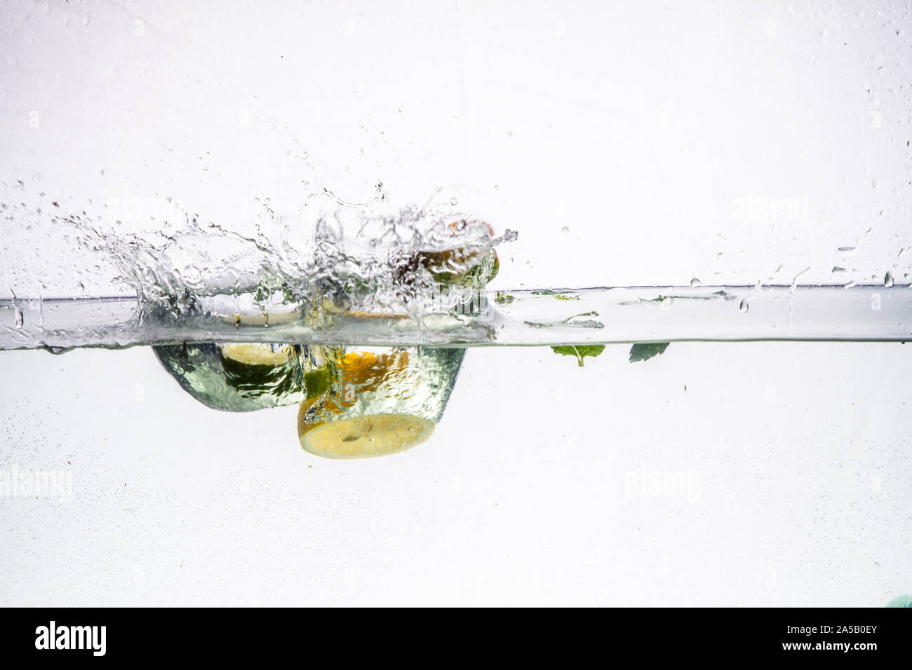 A background of bubbles forming in blue water after fruits is dropped ...