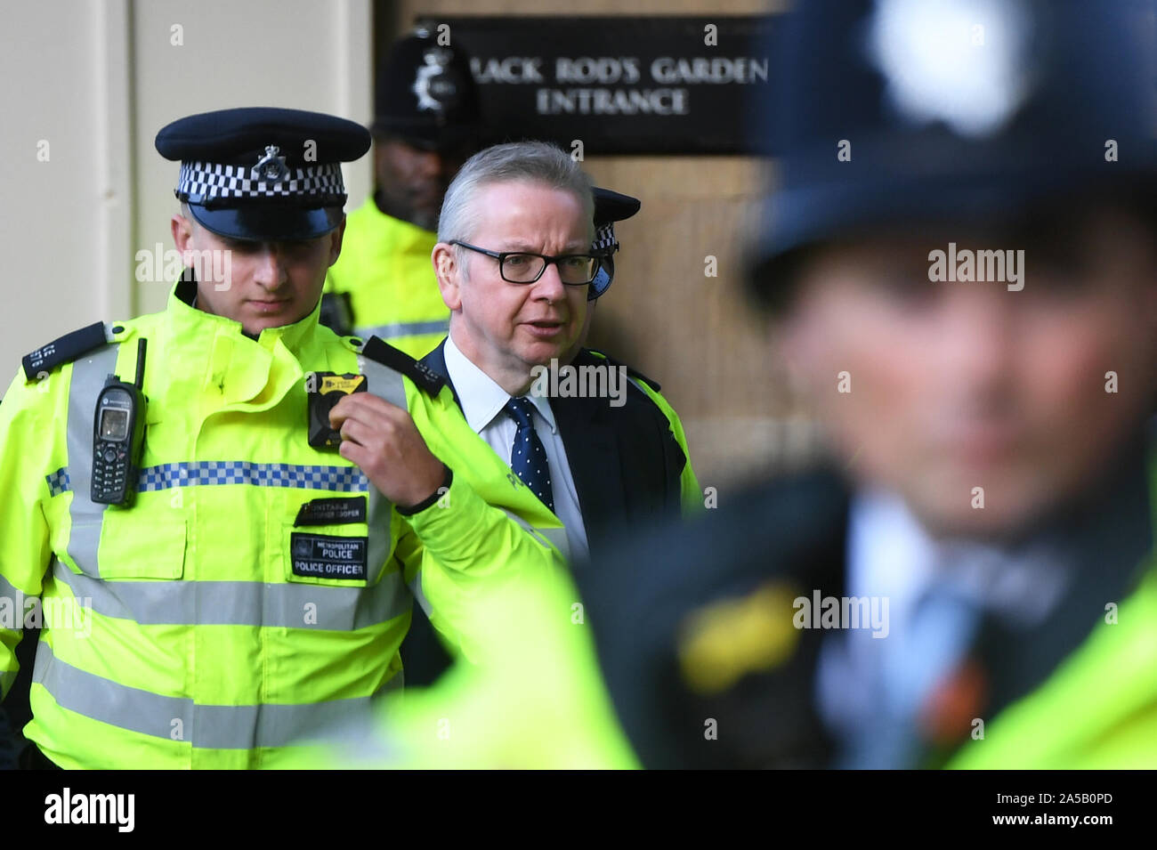 Police officers escort Chancellor of the Duchy of Lancaster Michael Gove after leaving the House of Commons, London, during an anti-Brexit, Let Us Be Heard rally in Parliament Square, after it was announced that the Letwin amendment, which seeks to avoid a no-deal Brexit on October 31, has been accepted Stock Photo