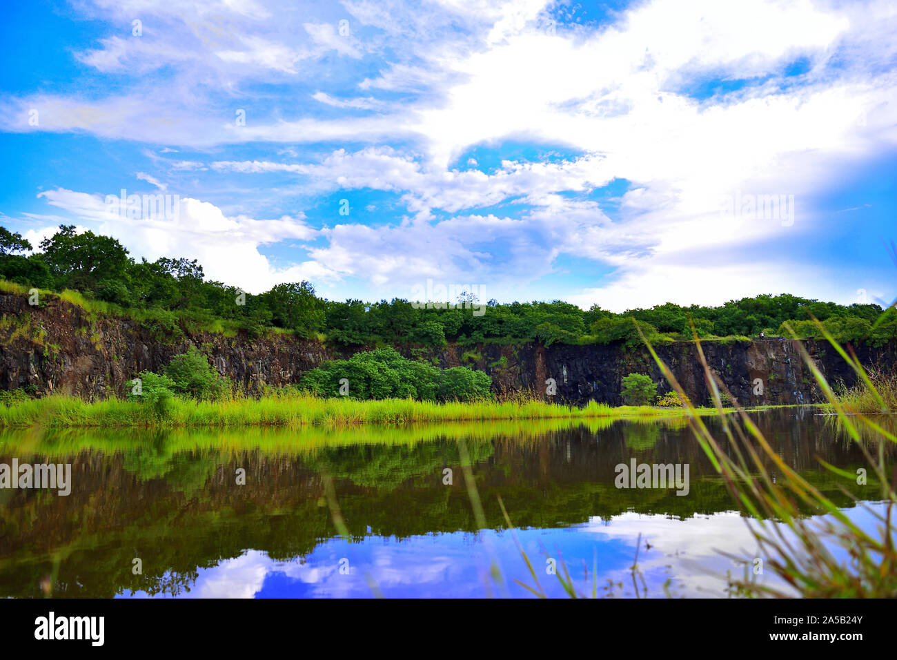 Beautiful lake surrounded by Green spread of rain forest with sky clear blue Stock Photo