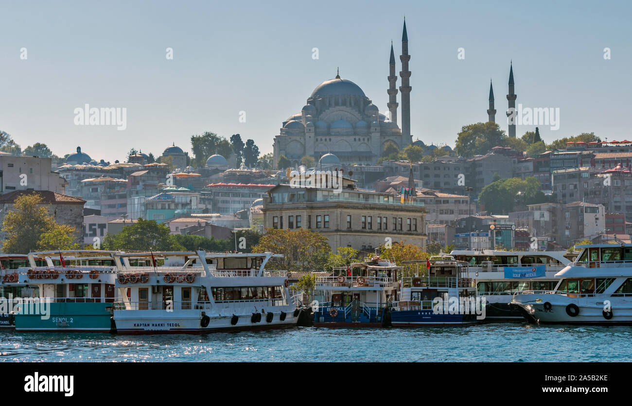 ISTANBUL TURKEY TOURIST BOATS ON THE BOSPHORUS THE SULEYMANIYE MOSQUE ON THE SKYLINE Stock Photo