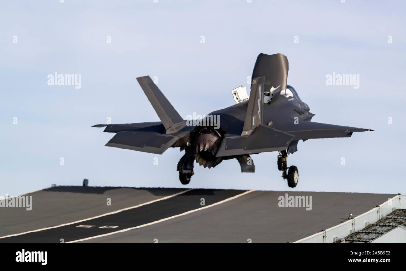 A Royal Air Force F-35B Lightning stealth fighter aircraft launches from the flight deck of the HMS Queen Elizabeth during flight operations October 17, 2019 in the Atlantic Ocean. HMS Queen Elizabeth, is the largest warship ever built by the Royal Navy and is currently deployed in support of exercise WESTLANT 19. Stock Photo