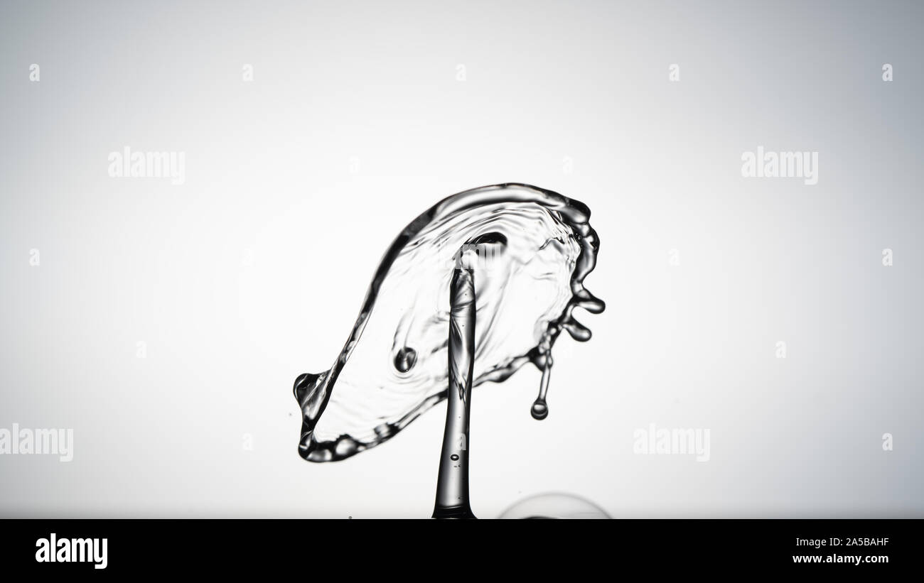 Close-up of a water drop falling on water surface Stock Photo - Alamy