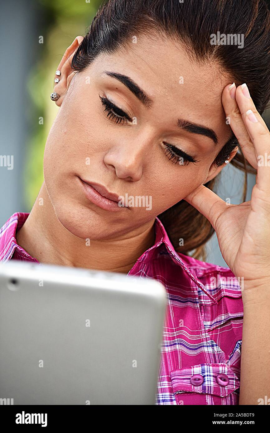 Stressed Young Woman Using Tablet Stock Photo