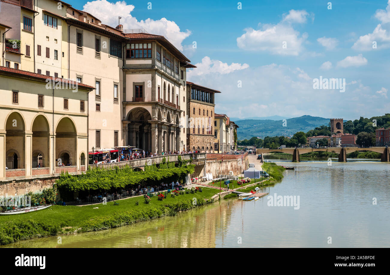 View of old medieval buildings by the southern bank of river Arno, in Florence, Italy, with the St. Trinity Bridge in the background. Stock Photo