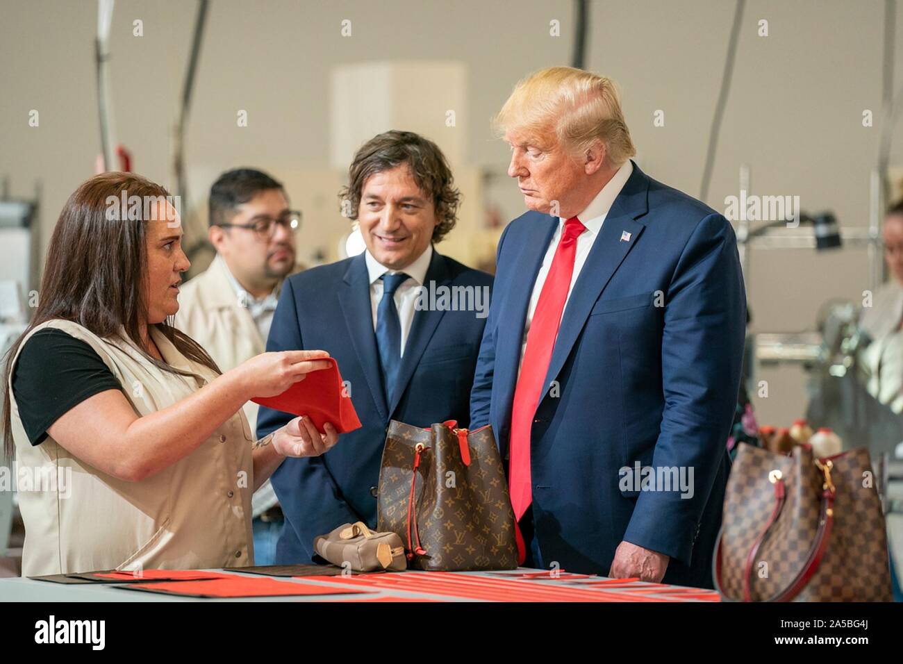 U.S President Donald Trump tours the newly opened Louis Vuitton Workshop  Rochambeau October 17, 2019 in Alvarado, Texas. Joining the president from  left to right are: Carlos Sousa, the general manager of