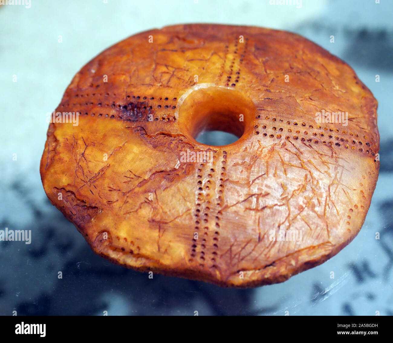 Ancient carving item of amber on display at the Amber Gallery, Nida, on The Curonian Spit, Lithuania. Stock Photo
