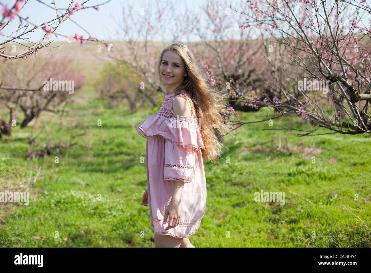 Blonde woman in peach dress hi-res stock photography and images - Alamy