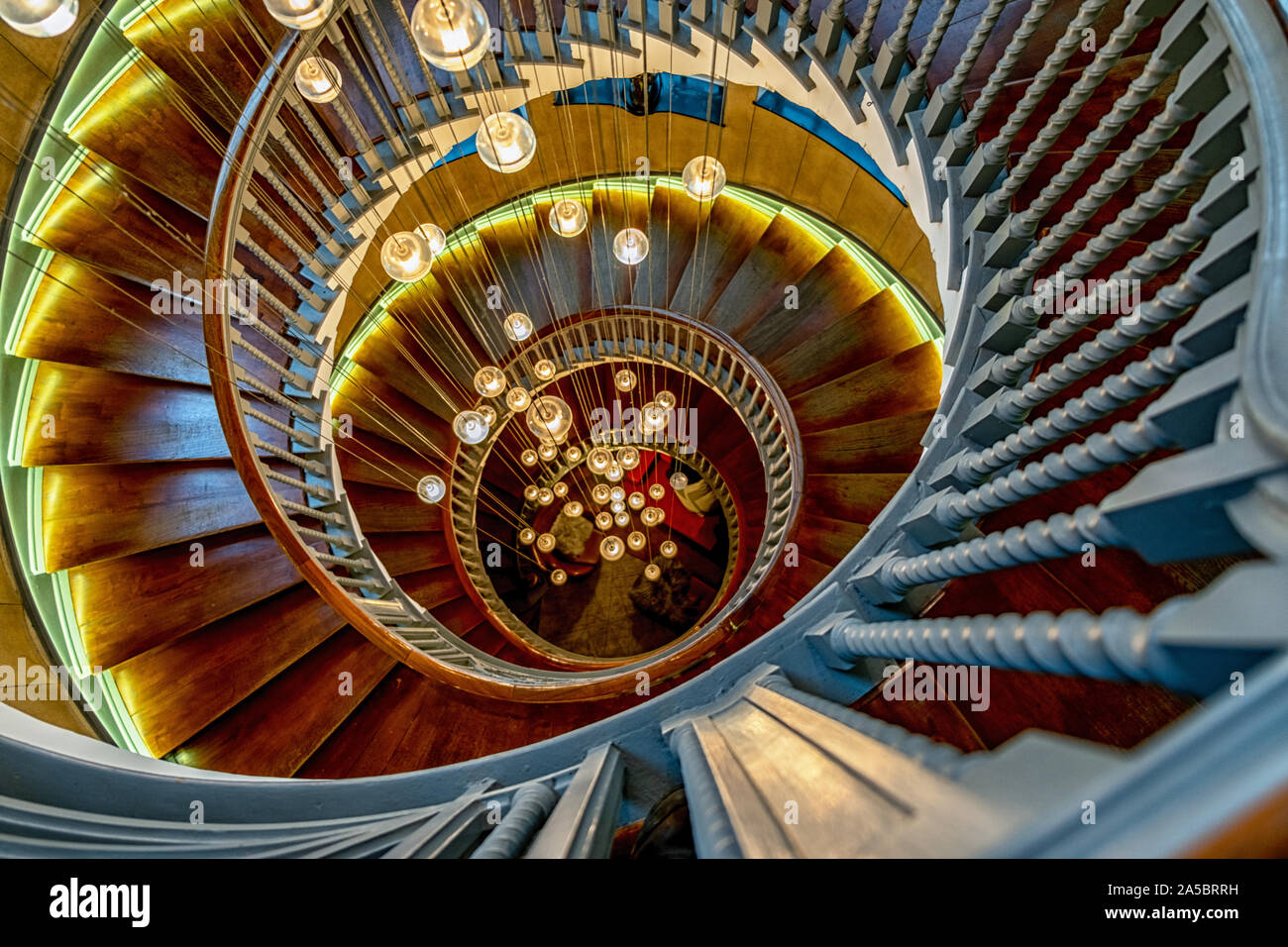 looking down Cecil Brewer spiral staircase featuring Bocci lights , located in Heal's department store,Tottenham Court Road, London, England, UK Stock Photo