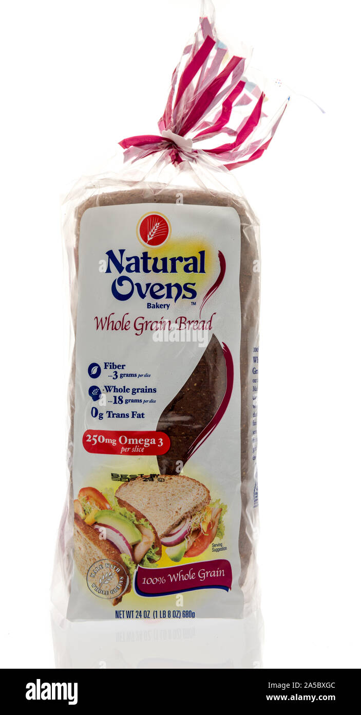 Winneconne, WI - 22 September 2019: A package of Natural Ovens bakery whole grain bread loaf on an isolated background. Stock Photo