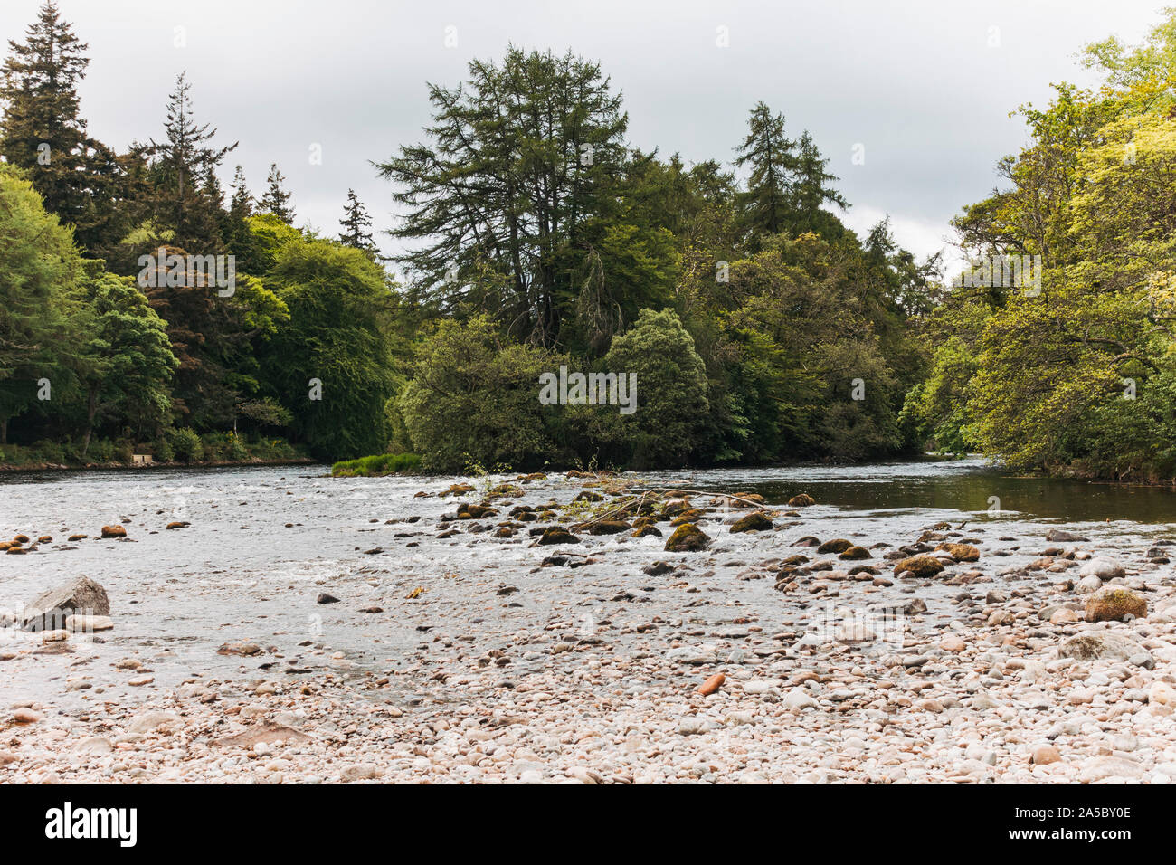 Upstream on the River Ness, looking toward Ness Islands, on a brisk spring day in Inverness, Scotland Stock Photo