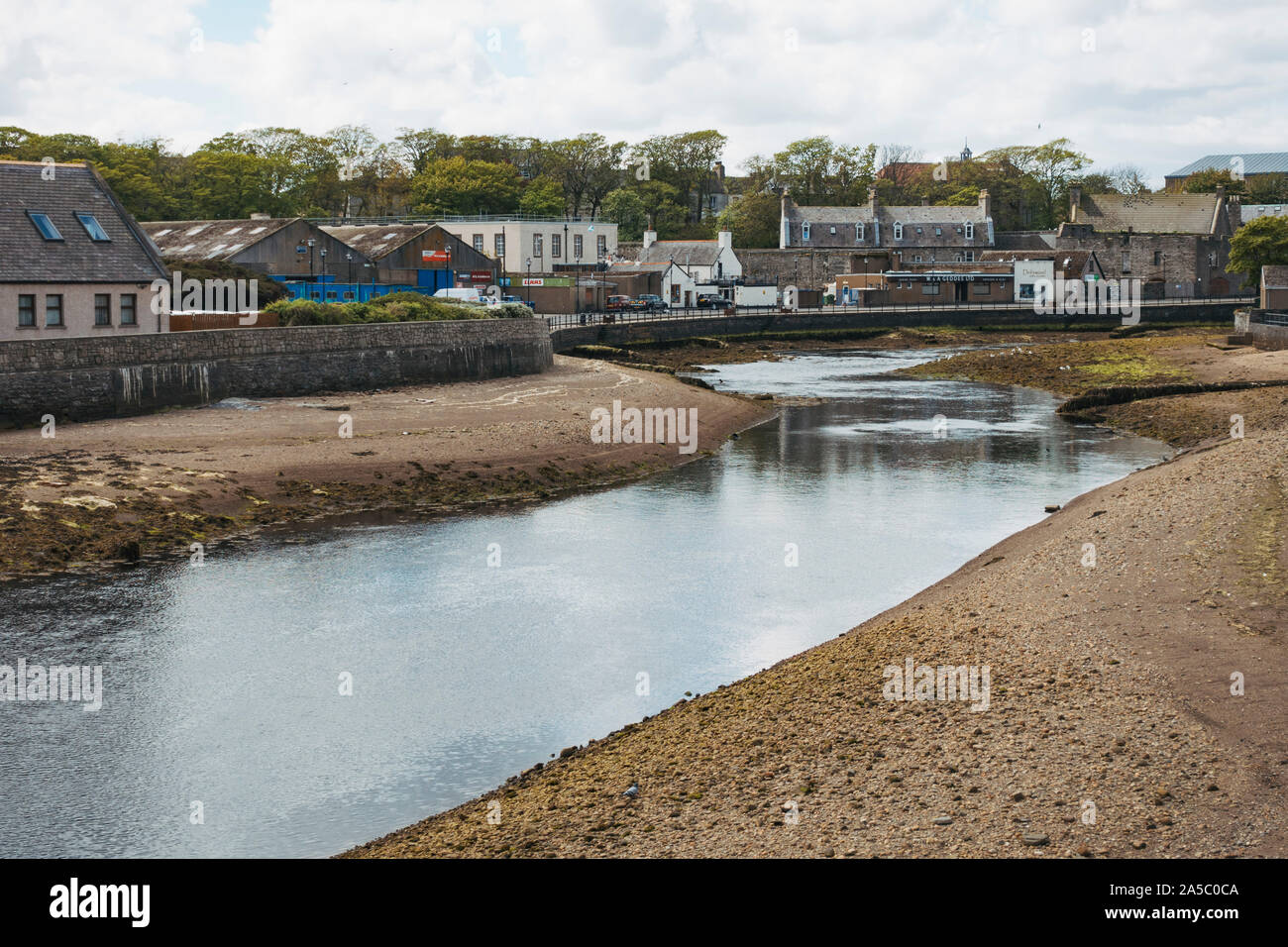 The banks of the Wick River as it runs through the town of Wick in the north of the United Kingdom Stock Photo