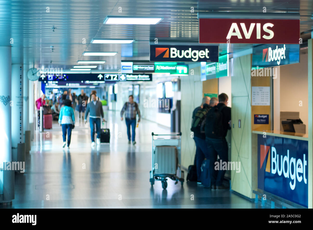 Car rental agencies in Helsinki - Vantaa Airport - Blurred people waiting on the the desk Stock Photo
