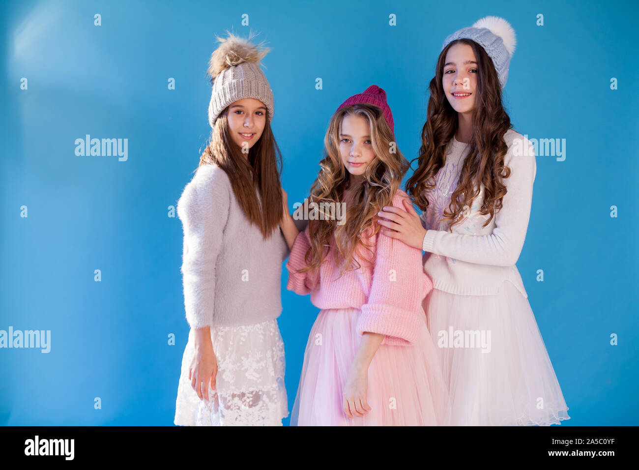 portrait of three beautiful girls in a winter hat Stock Photo
