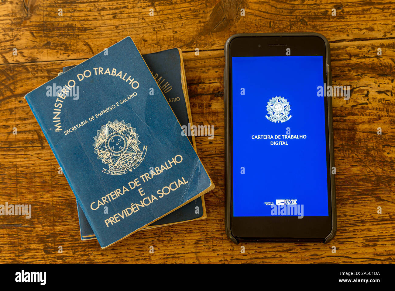 Rio de Janeiro, Brazil - October 19: a digital working Brazilian working permit, the CTPS, with the traditional paper document on a wooden table Stock Photo