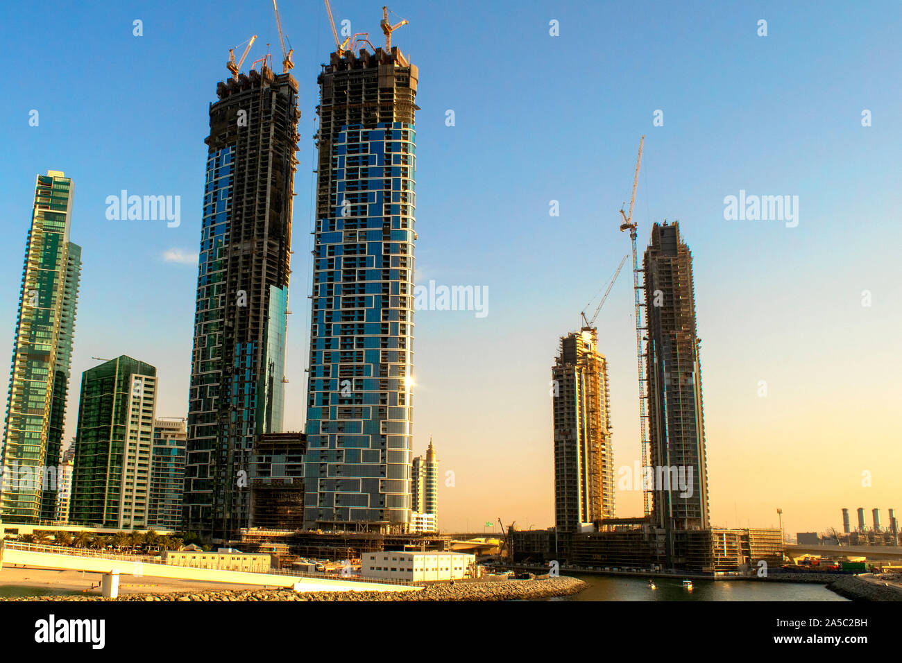 Dubai/UAE - October 17, 2019: Under construction tall buildings (skyscrapers) with yellow construction cranes in JBR. New luxury real estate Stock Photo