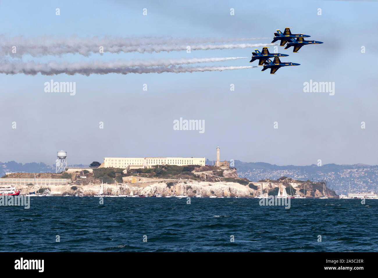 Blue Angels F-18 Hornets in diamond formation pass over Alcatraz during a 2019 San Francisco Fleet Week flight demonstration. Stock Photo