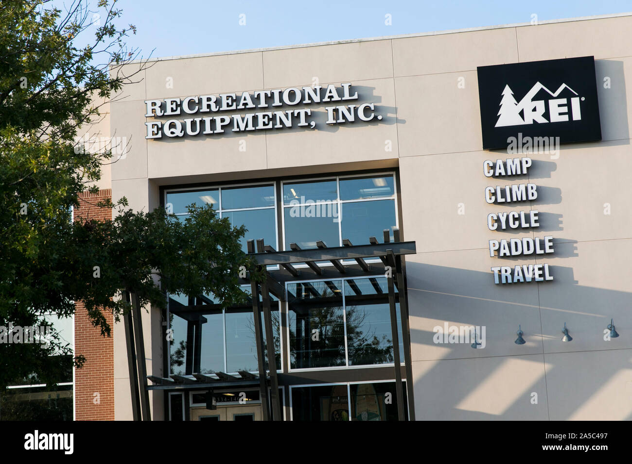 A logo sign outside of a Recreational Equipment, Inc. (REI) retail