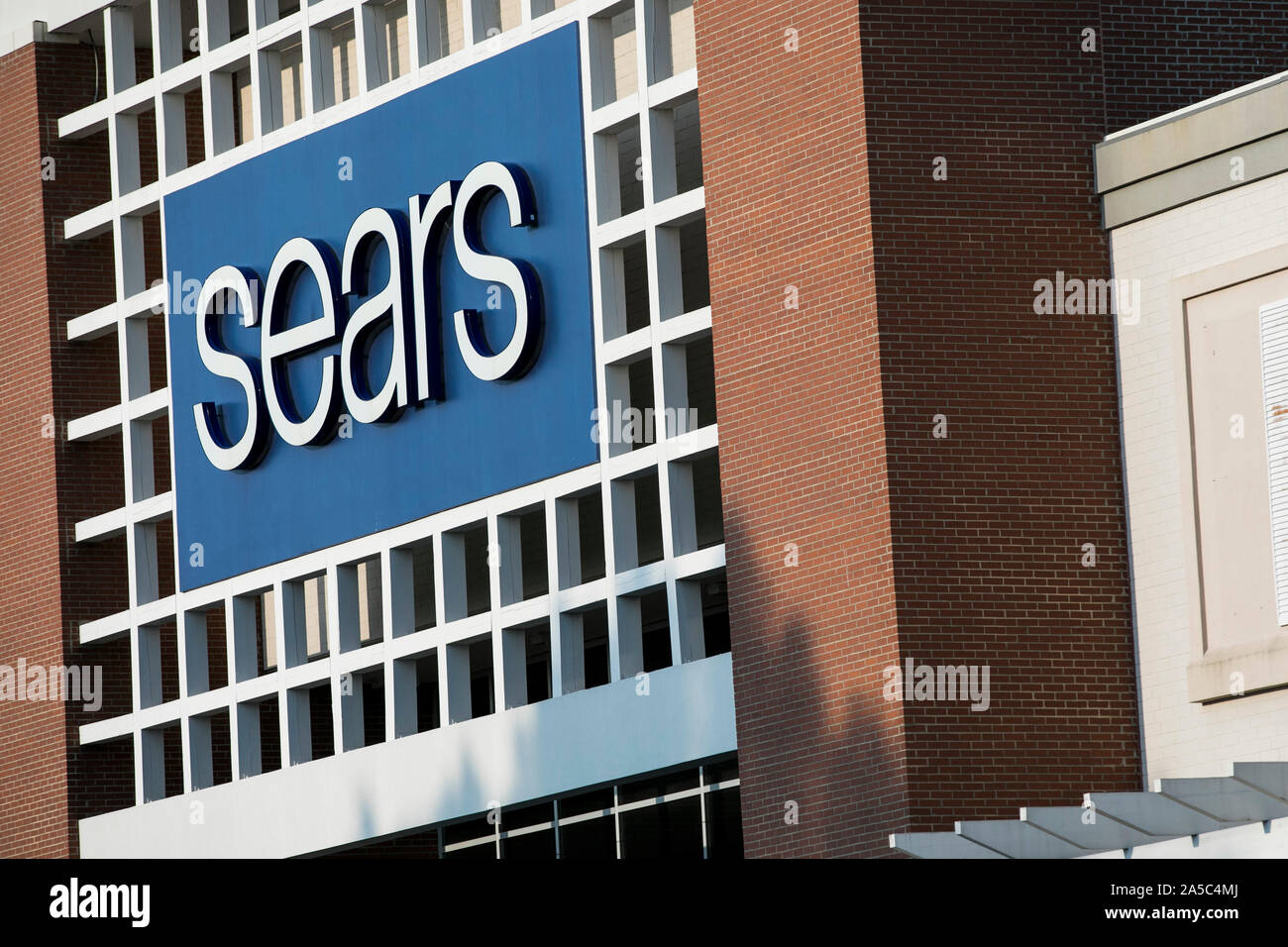 A logo sign outside of a Sears retail store location in Greensboro ...