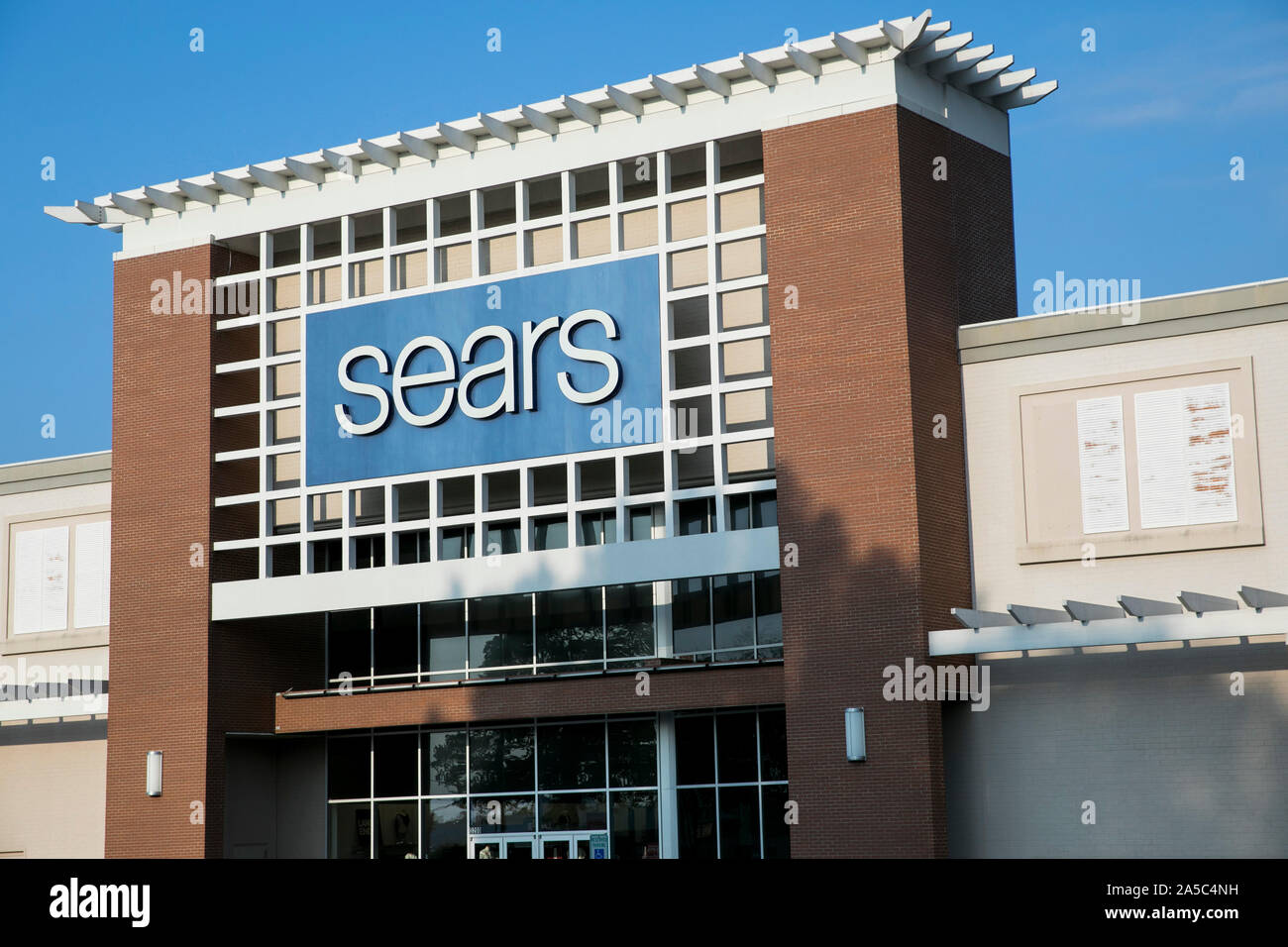 A logo sign outside of a Sears retail store location in Greensboro ...