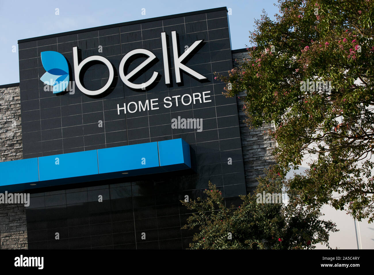 A logo sign outside of a Belk Home Store location in Greensboro, North