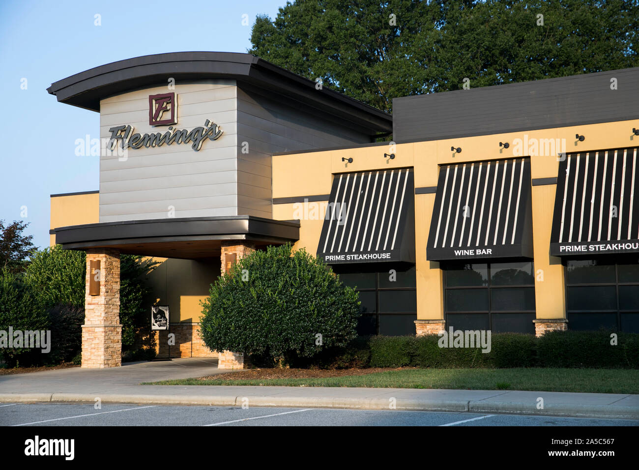 A logo sign outside of a Fleming's Prime Steakhouse restaurant location