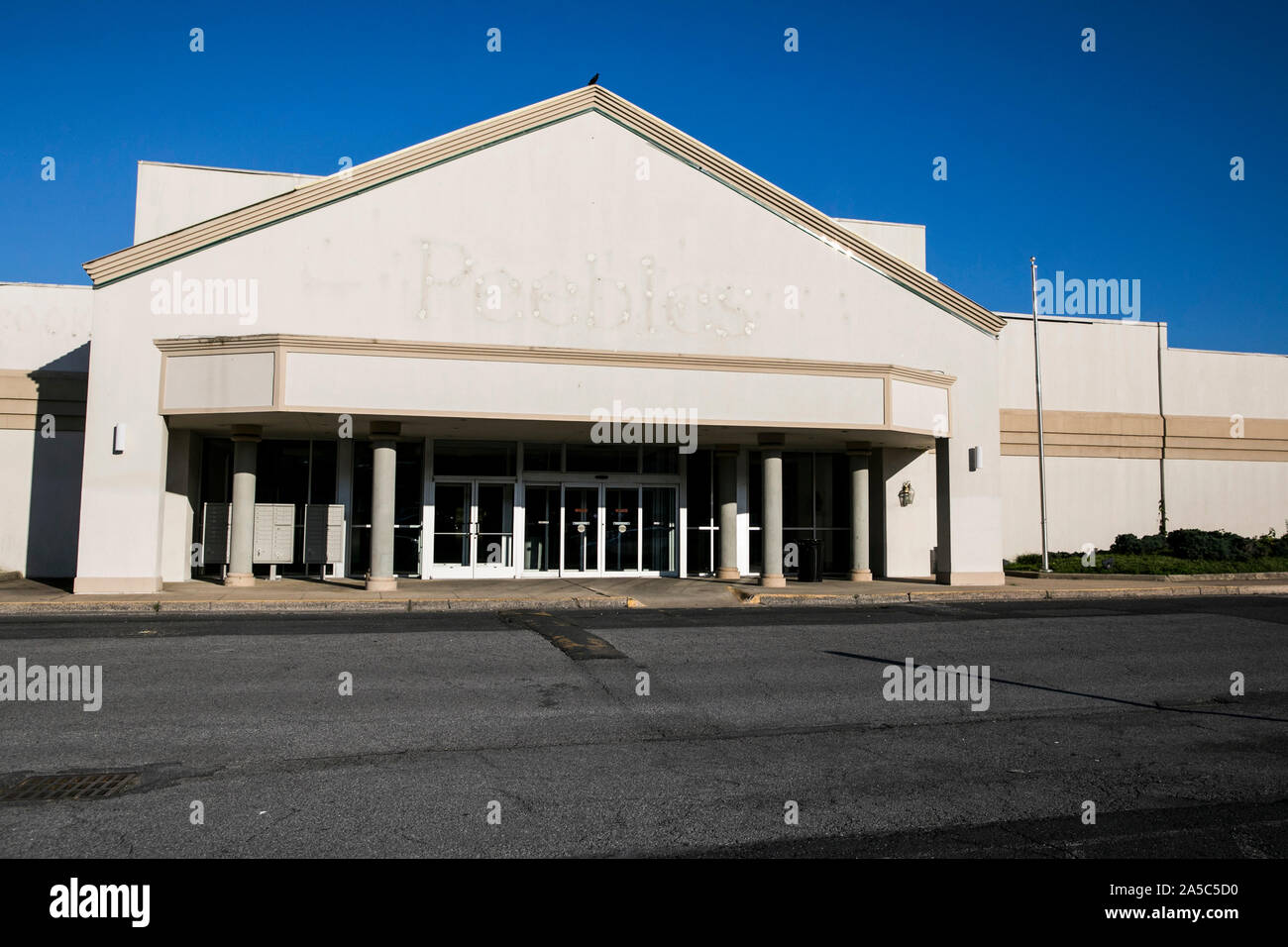 The faded outline of a logo sign outside of a closed and abandoned Peebles retail store location in Staunton, Virginia on September 15, 2019. Stock Photo