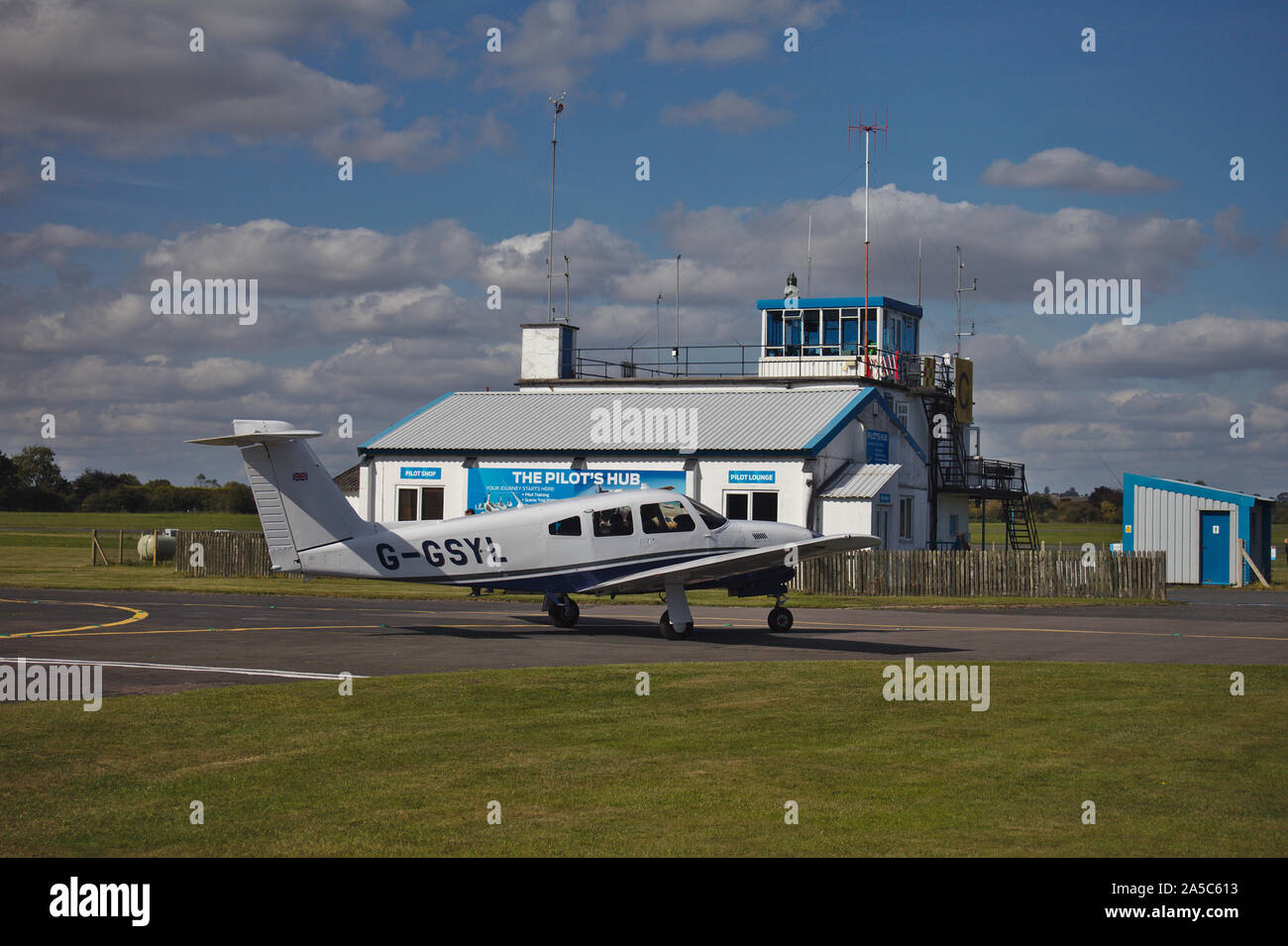 Light aircraft taxiing near control tower. Wolverhampton Halfpenny Green Airport. South Staffordshire. UK Stock Photo
