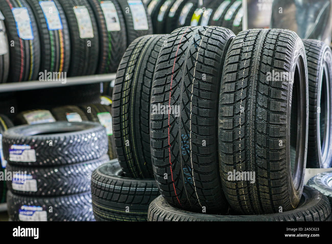 new winter tire sets without studs at tire shop Stock Photo