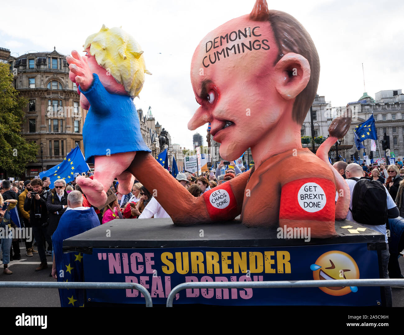 London, UK, 19 Oct 2019. Peoples Vote March. While Parliament debated the deal negotiated by PM Boris Johnson with the EU hundreds of thousands of anti Brexit protestors marched from Park Lane to Parliament Square. Pictured effigies of Boris Johnson and Dominic Cummings on small float parked in Trafalgar Square. Boris Johnson depicted as Dominic Cummings puppet. The Dominic Cummings effigy has horns and tail, and on forehead written Demonic Cummings. Credit: Stephen Bell/Alamy Stock Photo