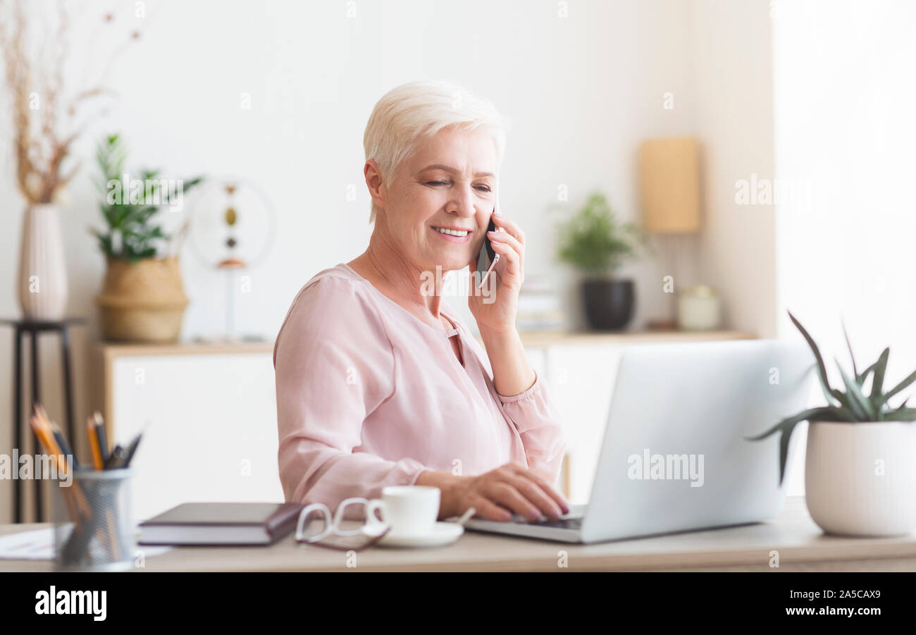 Energetic senior business lady working from home Stock Photo