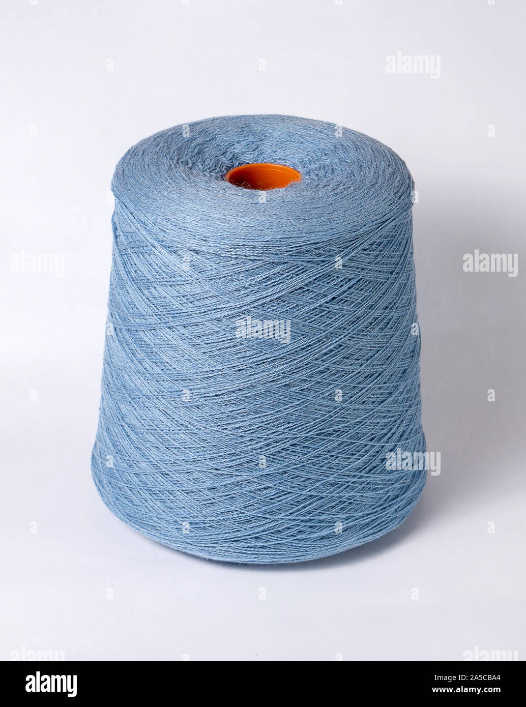 bobbin of yarn on a white background. Side view.Textile reel on