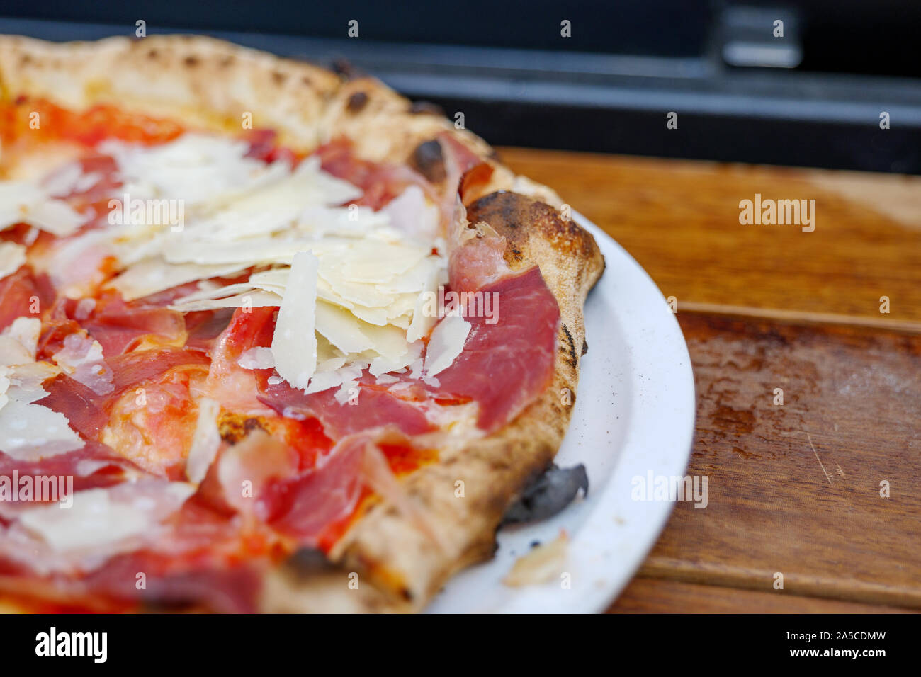 Parma Ham Pizza made with classic wood fired oven, on top with Parmesan