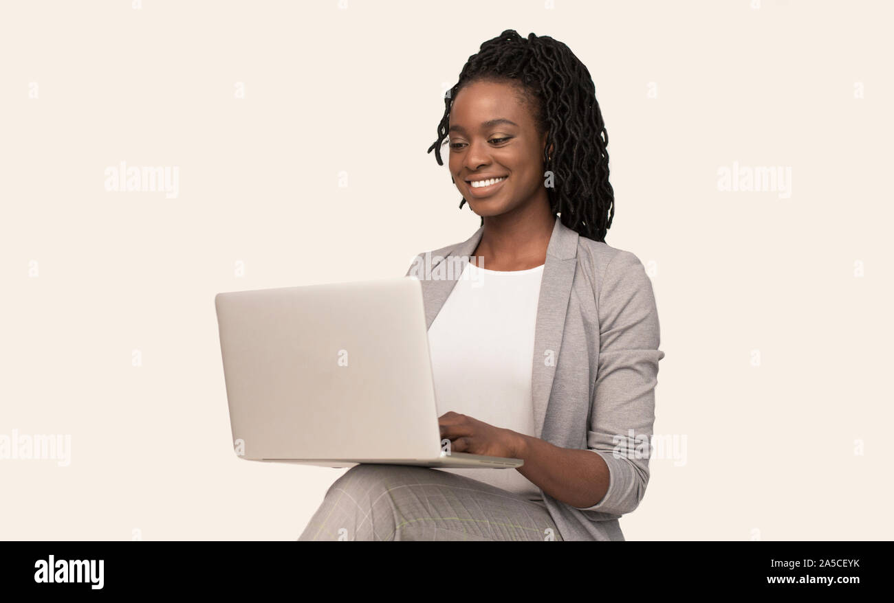 African American Girl Working On Laptop Sitting Over White Background ...
