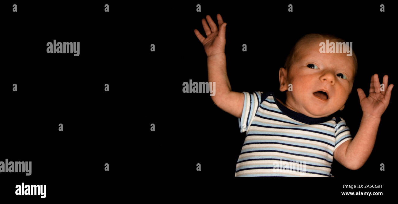 A 3 Week Old Baby Poses on a Black Background. Perfect for Memes with