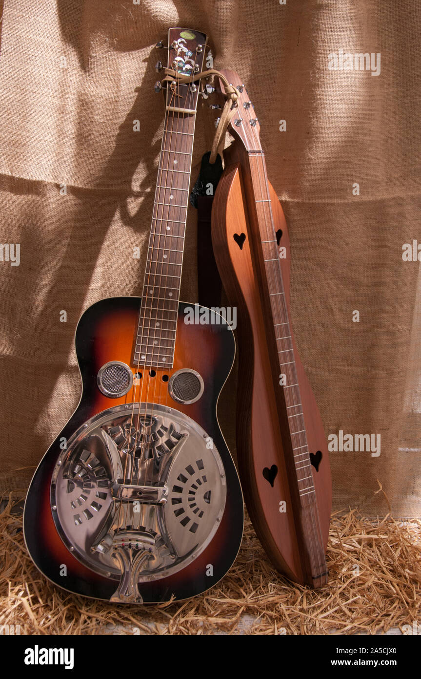 Acoustic Appalachian bluegrass and country instruments await the musician while propped up on a burlap backdrop. Stock Photo