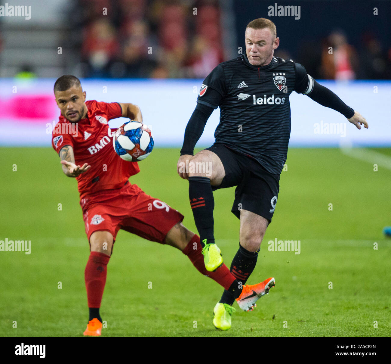 Toronto, Canada. 19th Oct, 2019. Wayne Rooney (R) of D.C. United vies with Auro Jr. of Toronto FC during the first round match of the 2019 Major League Soccer (MLS) Cup Playoffs between D.C. United and Toronto FC at BMO Field in Toronto, Canada, Oct. 19, 2019. Credit: Zou Zheng/Xinhua/Alamy Live News Stock Photo