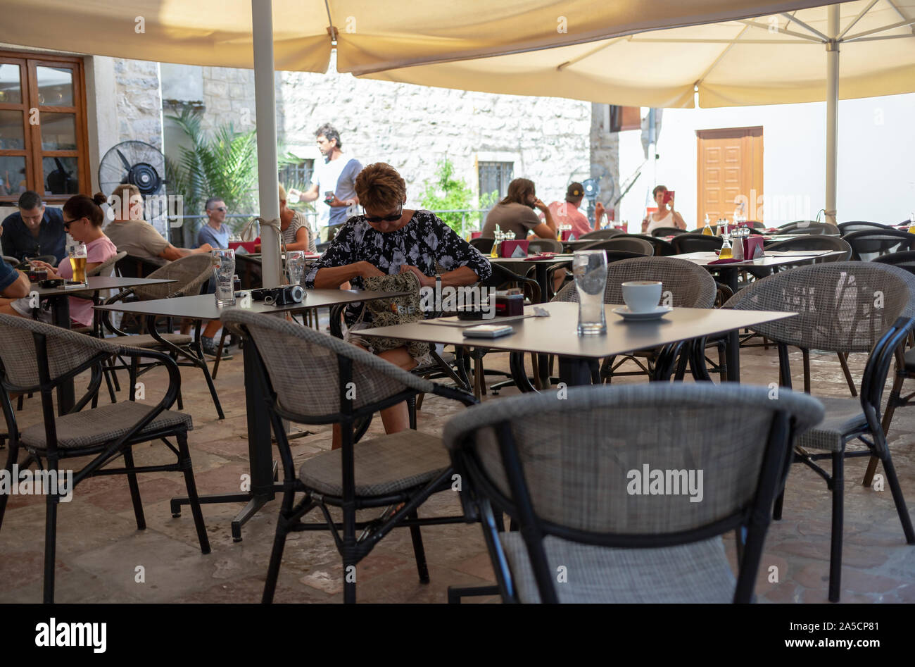 Montenegro, Sep 18, 2019: Guests sitting at an outdoor cafe in the Old Town of Kotor Stock Photo