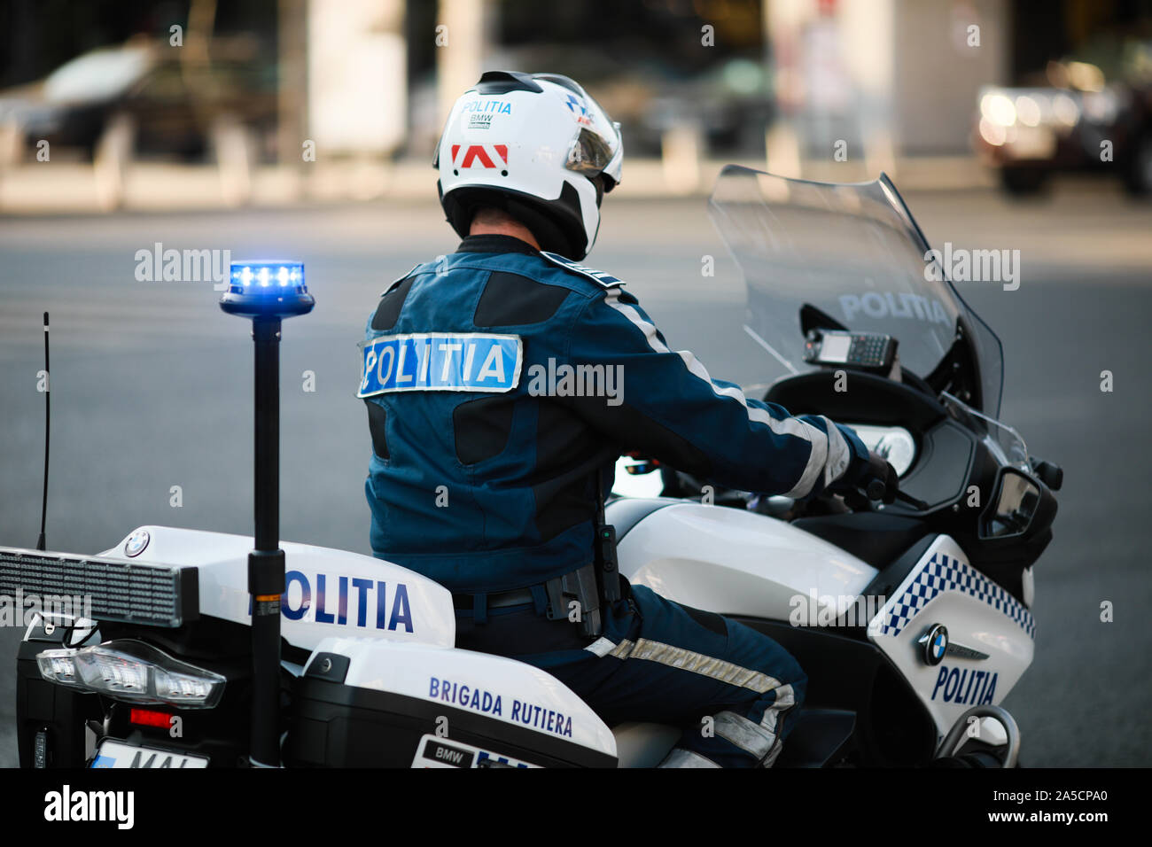Bucharest, Romania - October 19, 2019: Police officer riding a BMW motorcycle in the Bucharest city traffic. Stock Photo