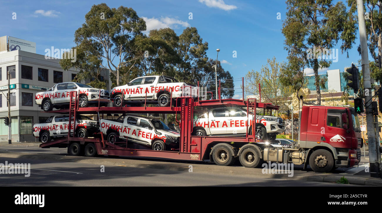Toyota Hilux vehicles loaded on auto transport trailer being transported in Melbourne in preparation for AFL Grand Final Parade 2019. Stock Photo