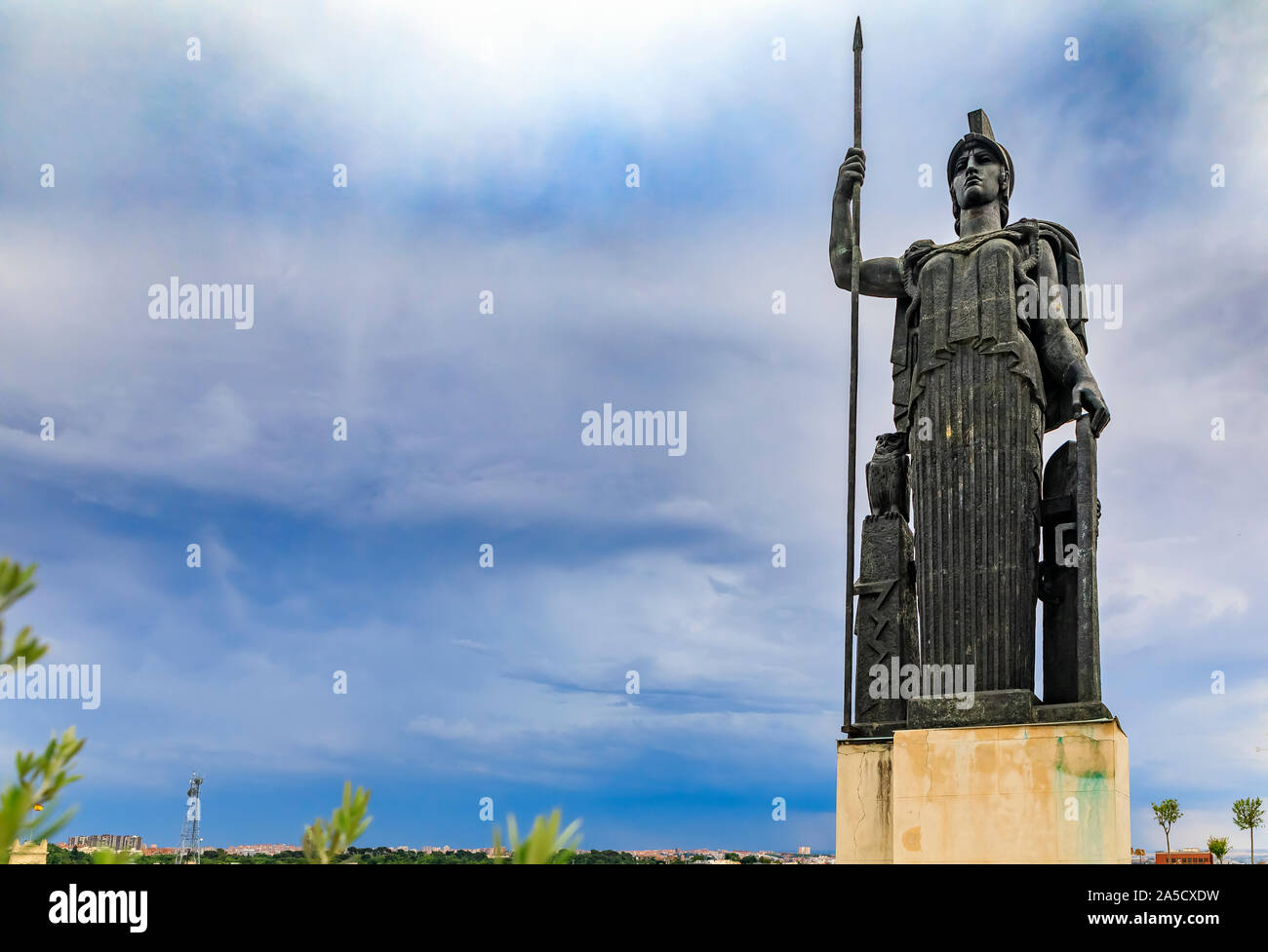 Madrid, Spain - June 4, 2017: Statue of Minerva Roman Goddess of Wisdom and Art on Circulo de Bellas Artes rooftop terrace, dramatic sky in background Stock Photo