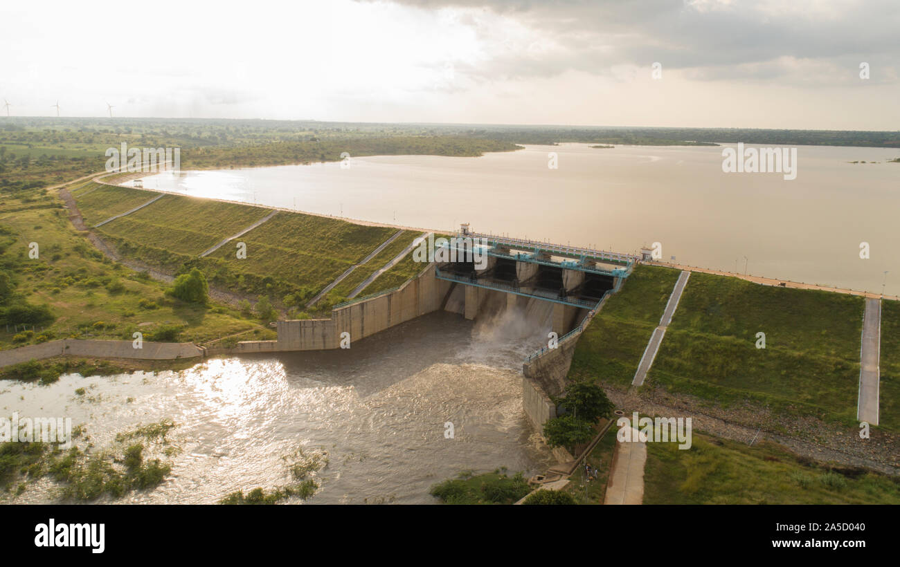 Aerial view of water reservoir with full of water and one of flood gate open at raichur, India Stock Photo