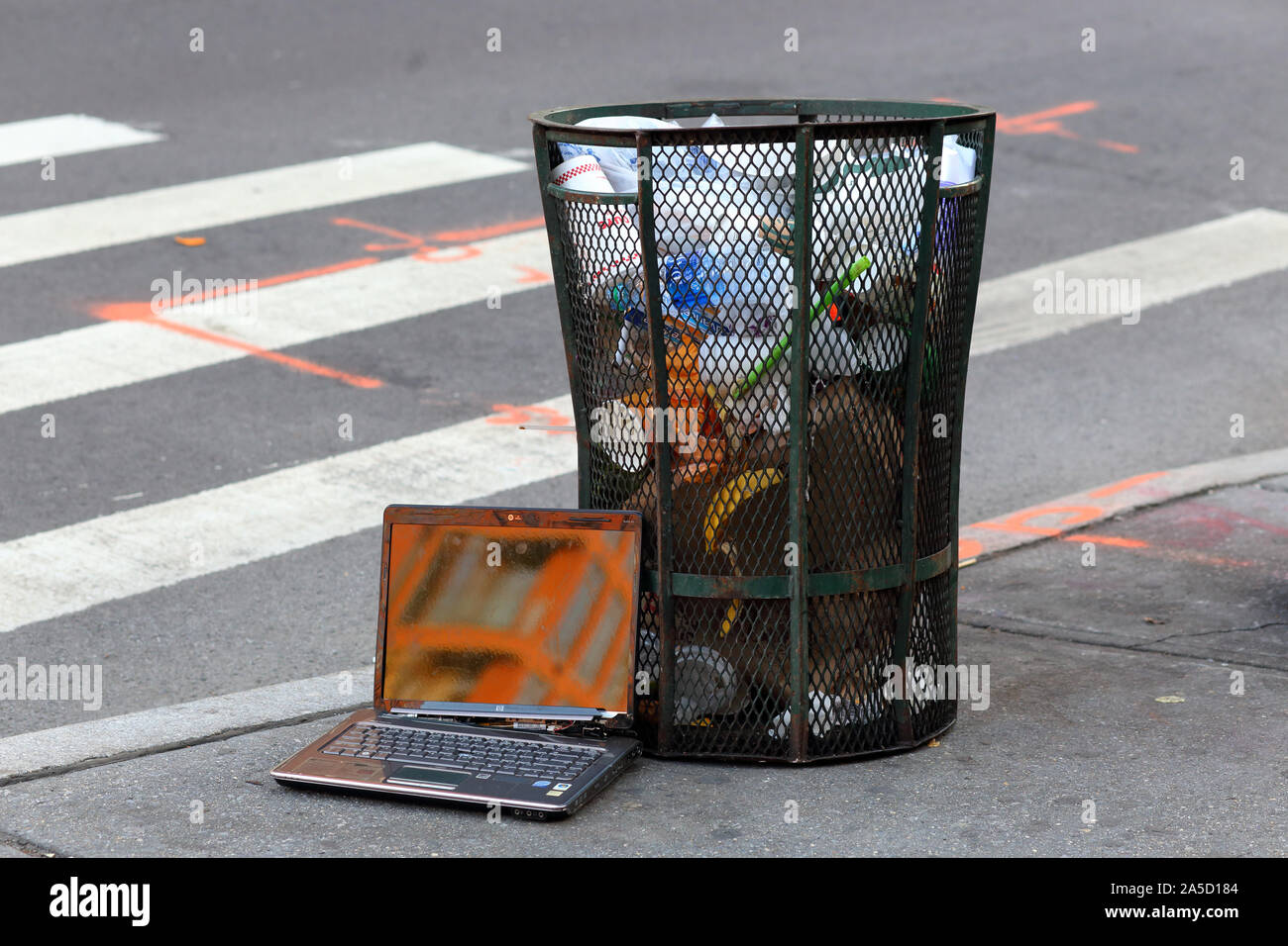 A broken laptop computer in the trash Stock Photo
