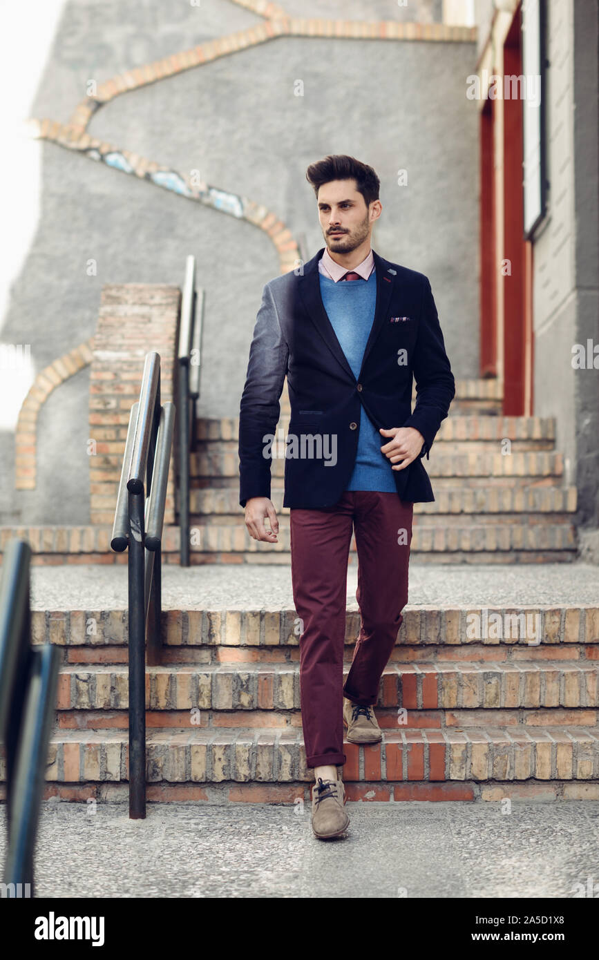 Attractive man wearing british elegant suit in the street. Modern hairstyle  Stock Photo - Alamy
