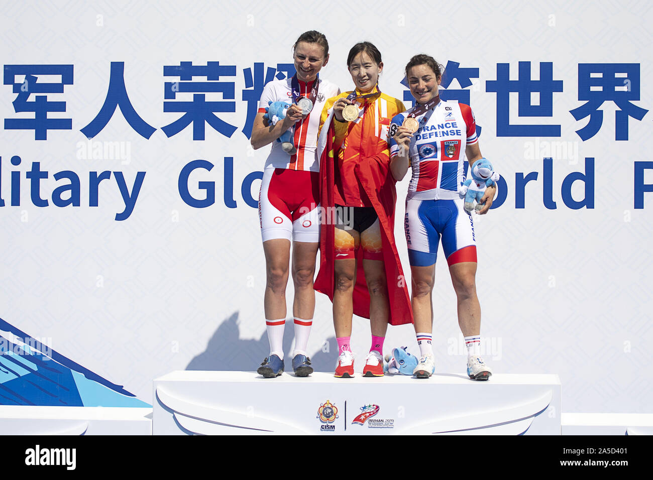 Wuhan, China's Hubei Province. 20th Oct, 2019. Zhao Xisha (C) of China, Katarzyna Pawlowska (L) of Poland and Pascale Jeuland of France pose for photos during the awarding ceremony of the women's individual road race final of the cycling road at the 7th CISM Military World Games in Wuhan, capital of central China's Hubei Province, Oct. 20, 2019. Zhao Xisha claimed the title of the event. Credit: Xiong Qi/Xinhua/Alamy Live News Stock Photo