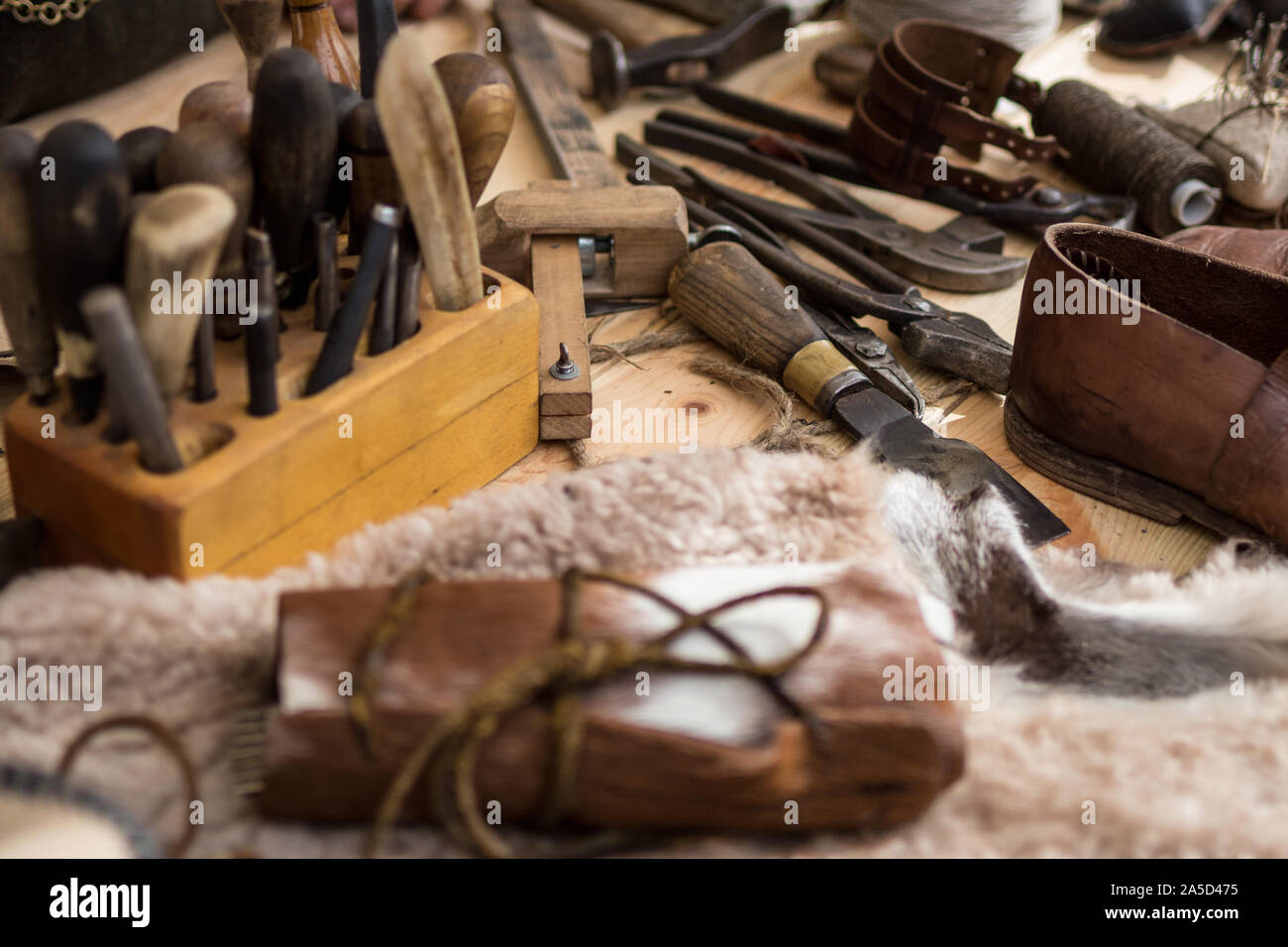 Set of leather working tools on working desk Stock Photo