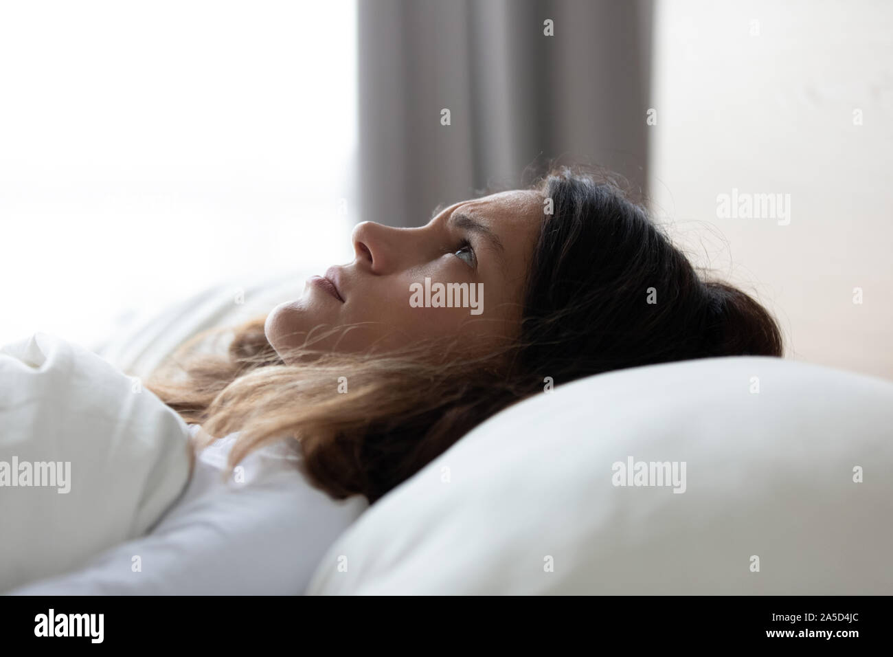 Unhappy young woman suffering from insomnia at home. Stock Photo