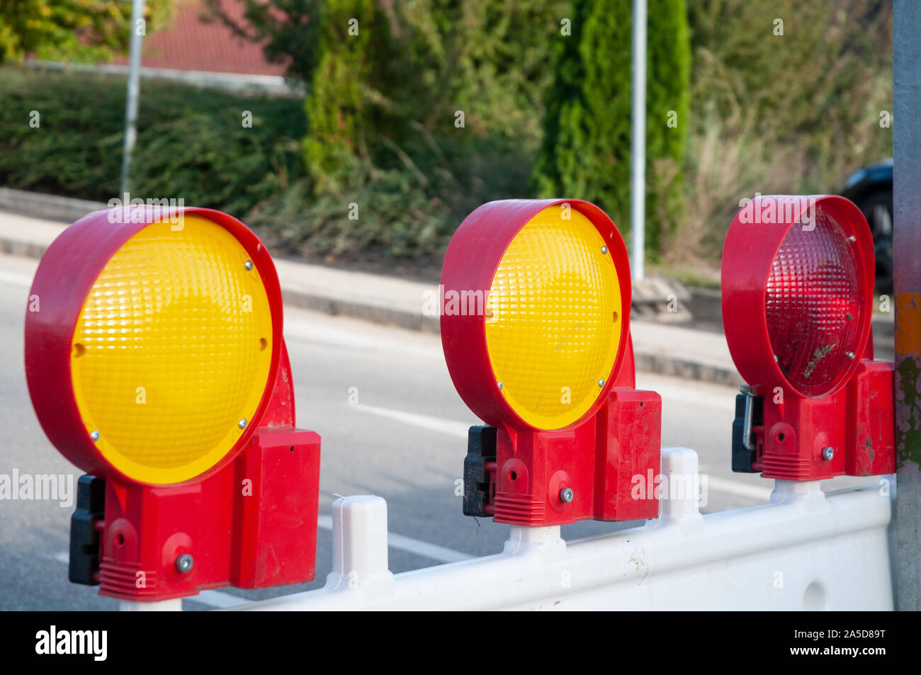 safety flash lights at plastic barriers at road construction site Stock