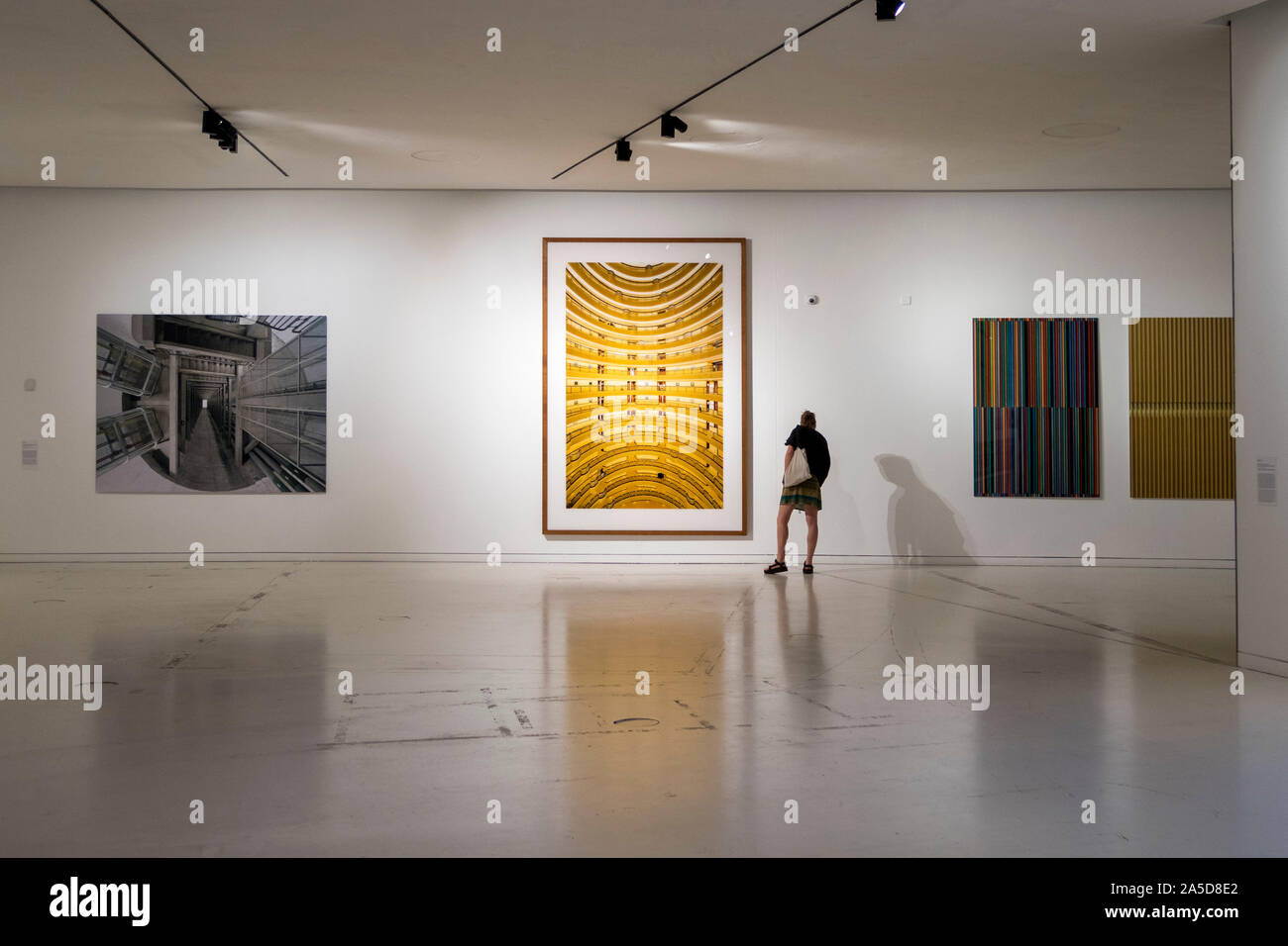 Person admiring an Andreas Gursky photograph at the MAAT Museum of Art Architecture and Technology in Lisbon, Portugal Stock Photo