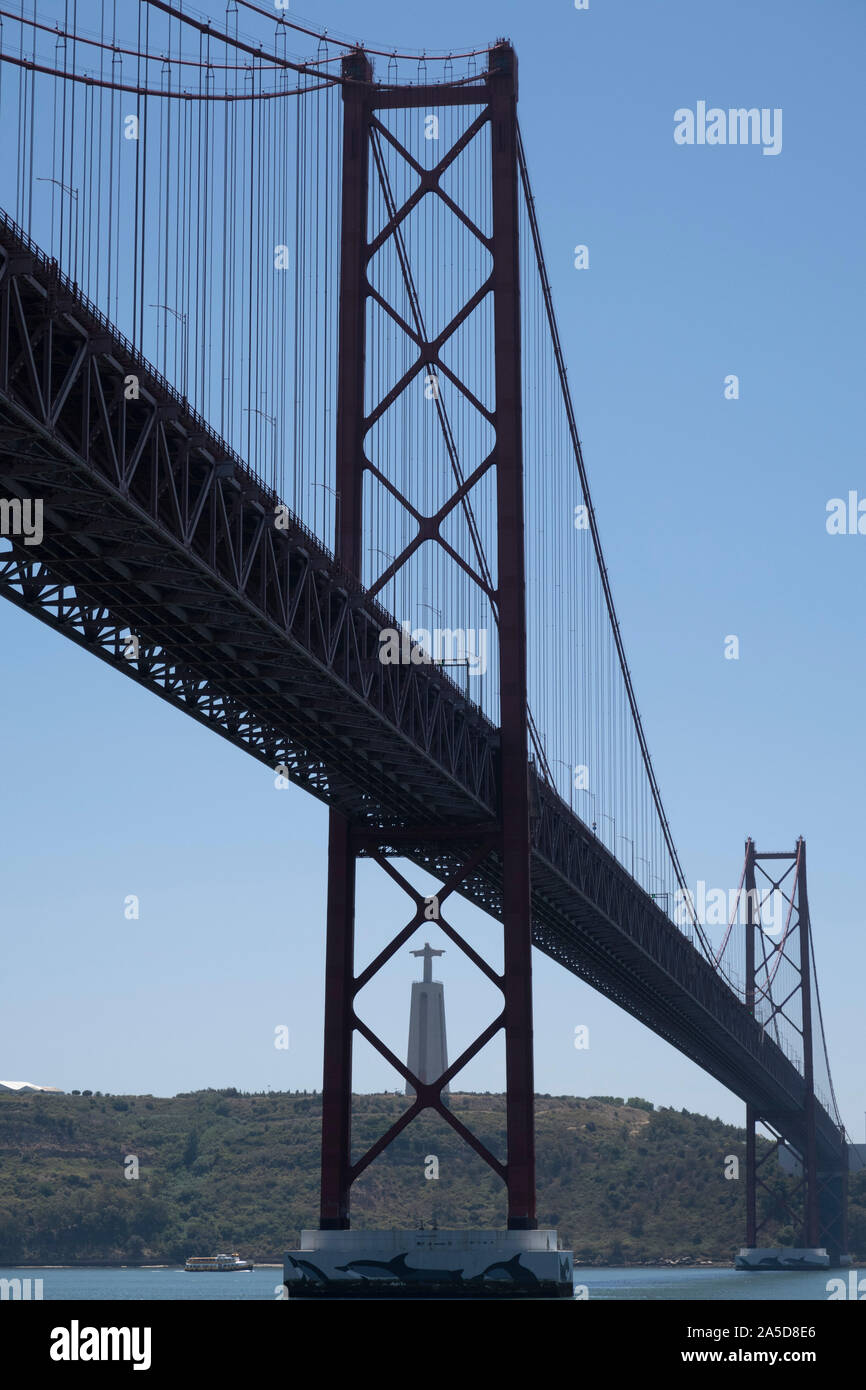 Ponte 25 de Abril suspension bridge over the Tagus river and the Sanctuary of Christ the King Cristo Rei statue overlooking Lisbon, Portugal Stock Photo