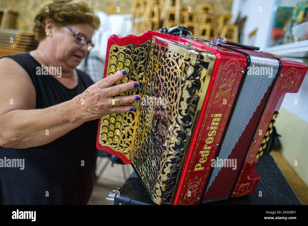 Woman holding a red Pedrosini button accordion Stock Photo
